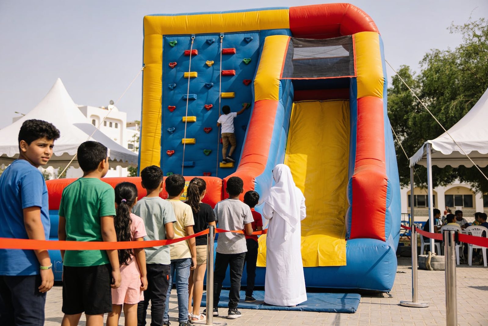 Inflatable climbing wall with a slide at a Dubai school event