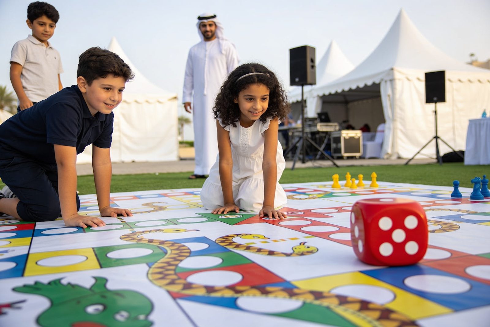 Kids playing giant snakes and ladders at a party in Dubai
