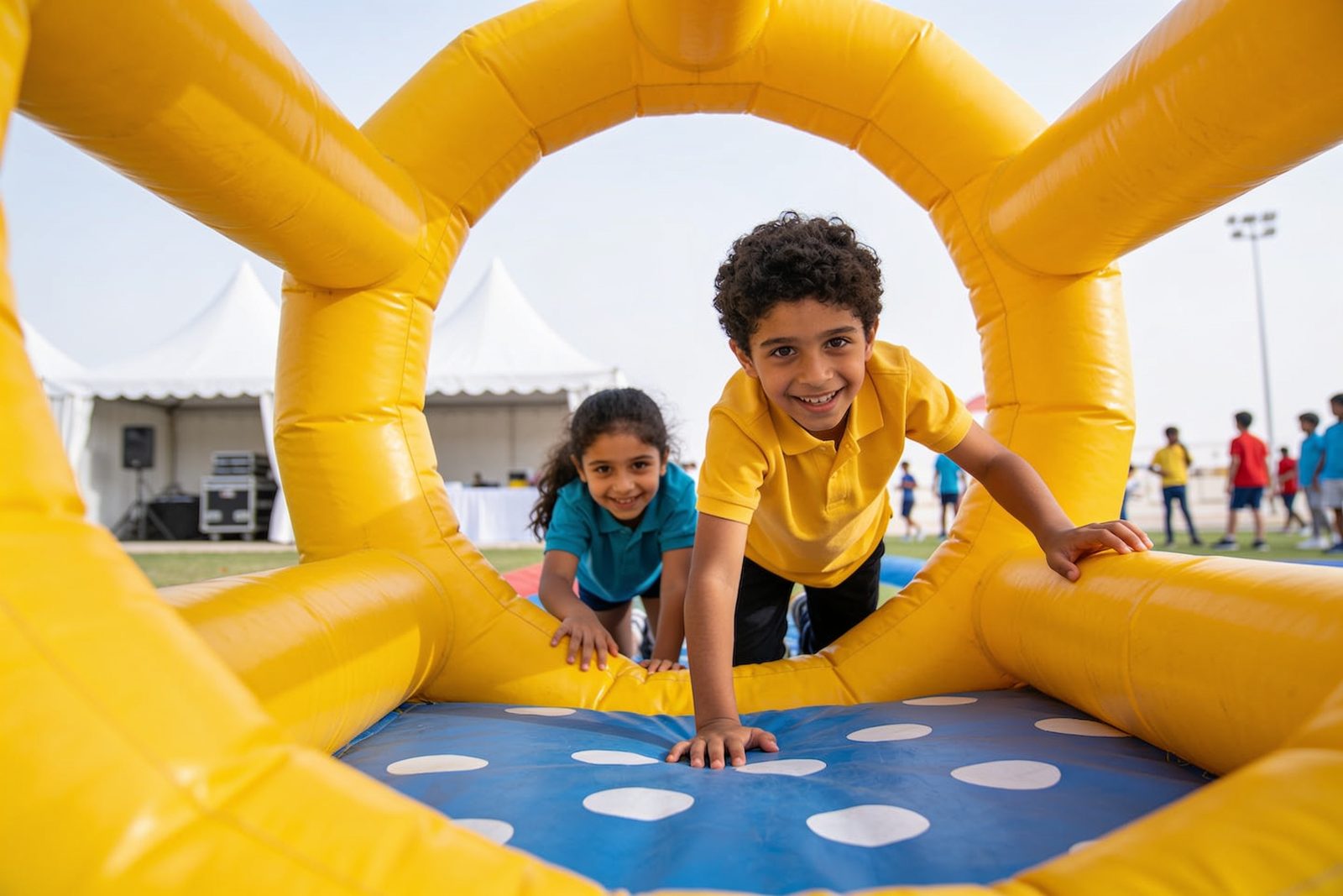 Children taking on an inflatable obstacle course during a school event in Dubai
