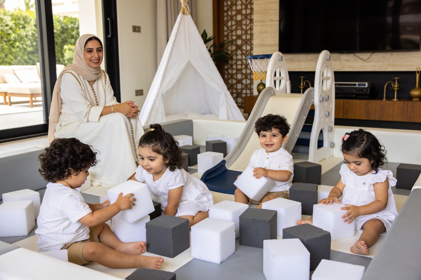 Toddlers playing in a soft play area at a first birthday in Dubai