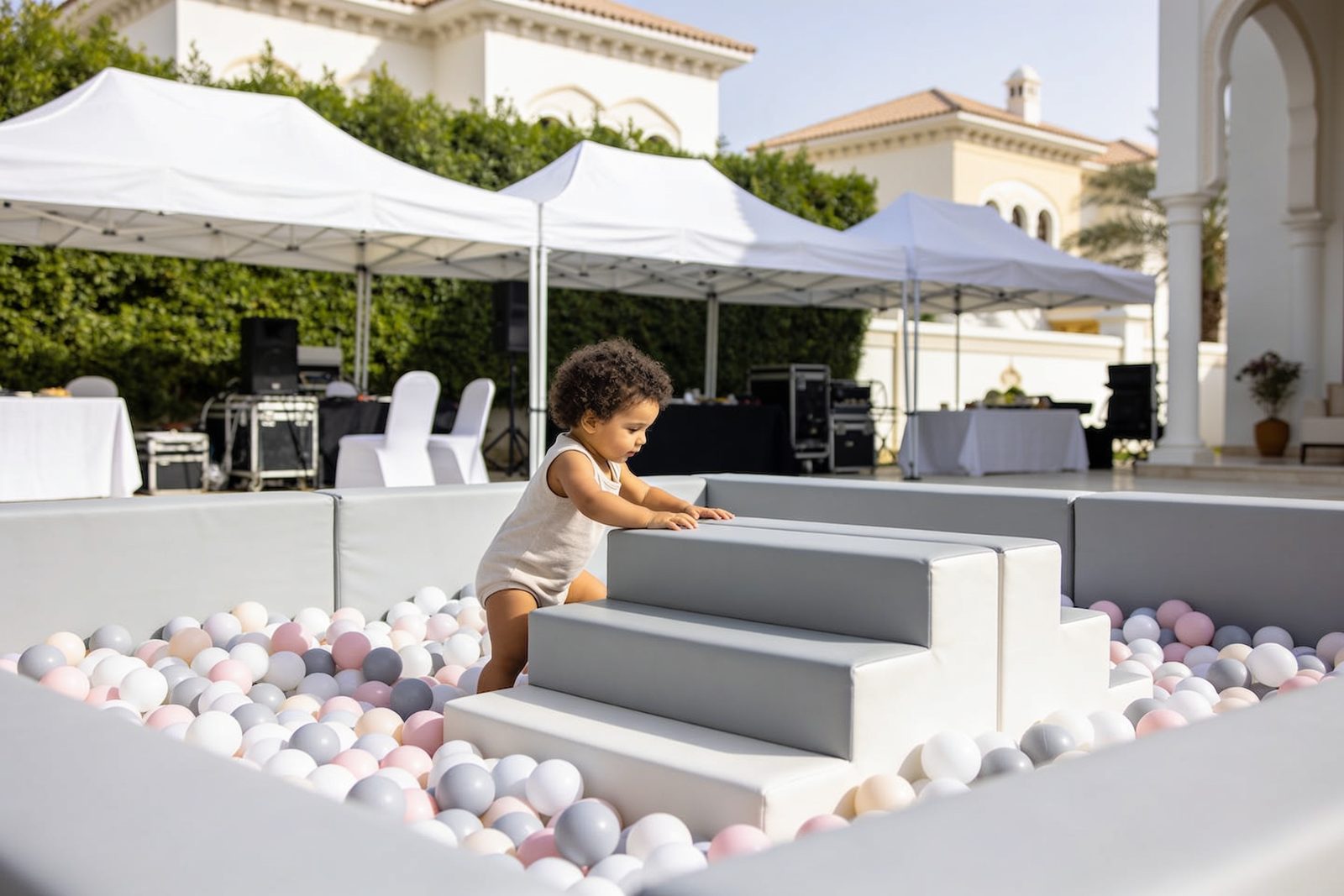 A white soft play set with ball pit set up inside a Dubai villa