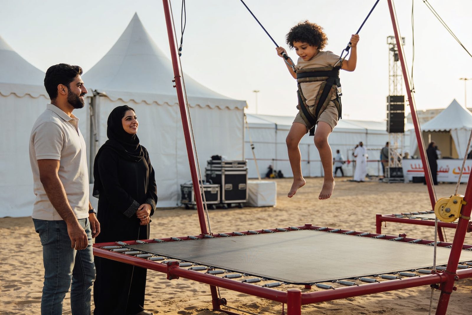 Child jumping on a bungee trampoline at a family festival in Dubai