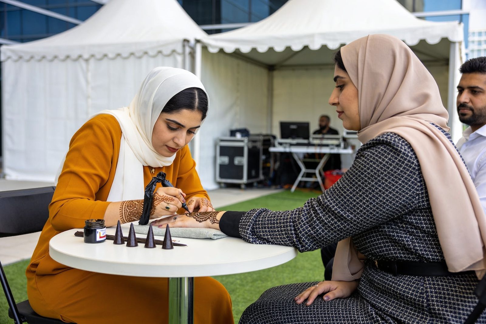 Henna artist working at a company National Day celebration in Dubai