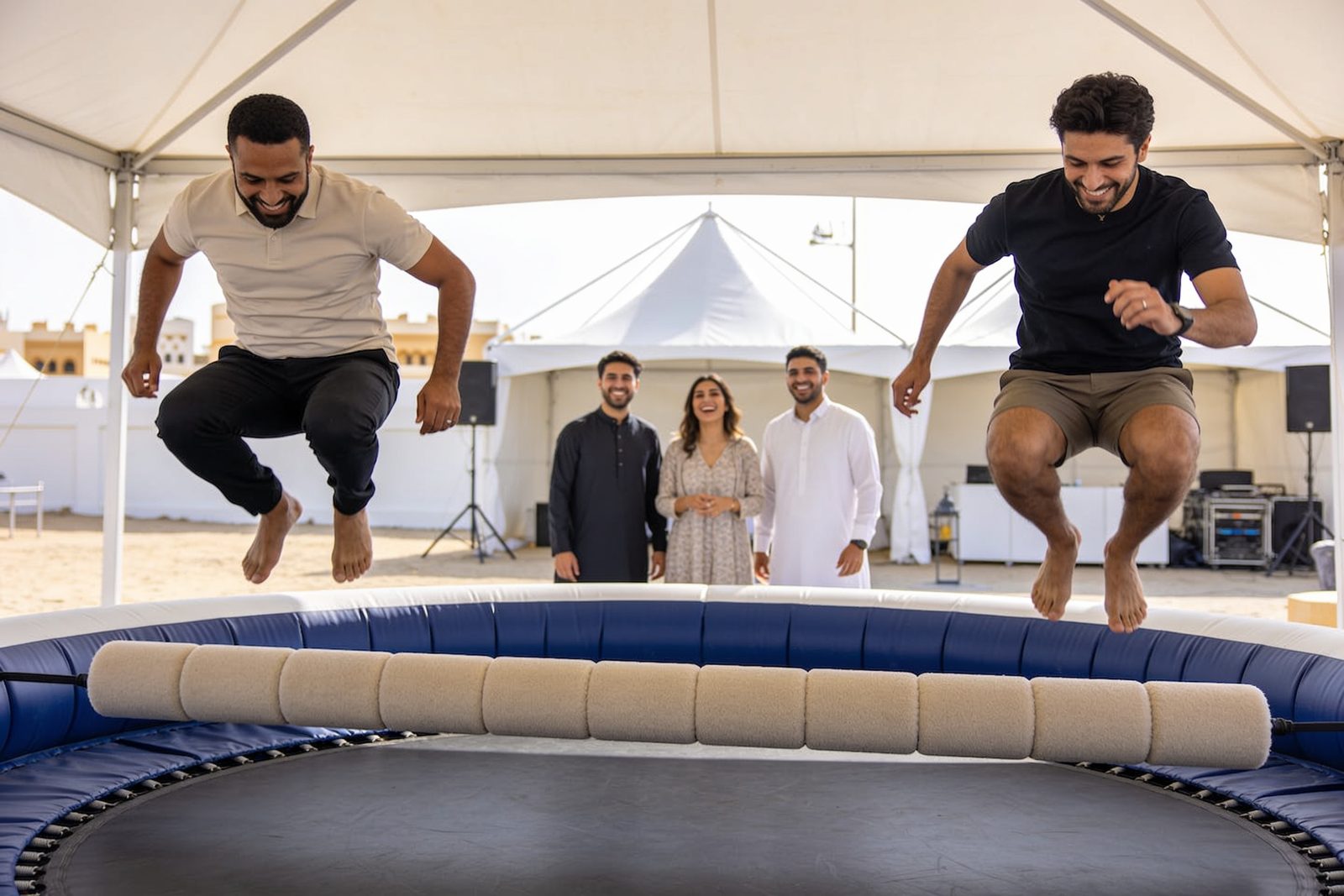Guests hopping over a padded sweeper bar in Dubai